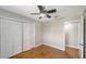 Comfortable bedroom with hardwood floors, a ceiling fan, and a spacious closet at 5706 10Th Avenue Dr W, Bradenton, FL 34209