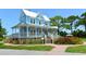Charming two-story blue home with a covered porch, gazebo and lush landscaping at 5706 10Th Avenue Dr W, Bradenton, FL 34209