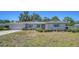 Charming single-story home with a well-maintained lawn and beautiful, light blue window shutters at 5706 10Th Avenue Dr W, Bradenton, FL 34209