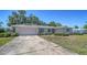 Street view of a single-story home with a long driveway and attached garage at 5706 10Th Avenue Dr W, Bradenton, FL 34209