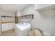 Functional laundry room with washer, dryer, utility sink and ample storage shelving at 5706 10Th Avenue Dr W, Bradenton, FL 34209