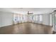 Open living room with hardwood floors, a ceiling fan, and plenty of natural light at 5706 10Th Avenue Dr W, Bradenton, FL 34209