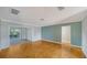 Open-concept living room with parquet floors and access to a screened patio at 5706 10Th Avenue Dr W, Bradenton, FL 34209