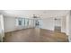 Bright living room with hardwood floors, a ceiling fan, and sliding glass doors at 5706 10Th Avenue Dr W, Bradenton, FL 34209