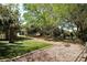 Community playground shaded by mature trees with artificial turf and play equipment at 5706 10Th Avenue Dr W, Bradenton, FL 34209