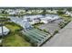 Aerial view featuring the clubhouse, shuffleboard courts, and community amenities at 577 Circlewood Dr # X7, Venice, FL 34293