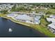 Community aerial view includes the clubhouse, pool, and scenic lakefront setting at 577 Circlewood Dr # X7, Venice, FL 34293