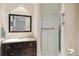 Bathroom featuring a dark vanity with a marble countertop and a glass shower at 577 Circlewood Dr # X7, Venice, FL 34293