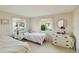 Cozy bedroom featuring twin beds, natural light, and decorative accents at 577 Circlewood Dr # X7, Venice, FL 34293