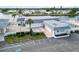 Aerial view showcases the community clubhouse and pool with ample parking and a waterside location at 577 Circlewood Dr # X7, Venice, FL 34293