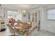 Charming dining area with a wooden table, upholstered chairs, a chandelier, and natural light at 577 Circlewood Dr # X7, Venice, FL 34293
