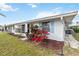 Charming exterior features white facade, blue shutters, and colorful landscaping, enhancing curb appeal at 577 Circlewood Dr # X7, Venice, FL 34293