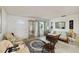 Bright and airy living room with comfortable seating, tiled floors, a display cabinet, and a large rug at 577 Circlewood Dr # X7, Venice, FL 34293