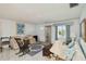 Cozy living room featuring vintage furniture, marble floors, and ample natural light from the window at 577 Circlewood Dr # X7, Venice, FL 34293