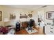 Comfortable home office with a wooden desk, shelving, a printer, and a view into the living area at 577 Circlewood Dr # X7, Venice, FL 34293