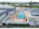 Community pool area with lounge chairs, umbrellas, and well-maintained landscaping at 577 Circlewood Dr # X7, Venice, FL 34293