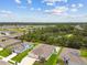Aerial view showcasing a home with a private pool, fenced yard and neighborhood pond at 5904 114Th E Dr, Parrish, FL 34219