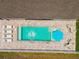 Aerial view of pool with outdoor lounge area, blue umbrella and white privacy fence at 5904 114Th E Dr, Parrish, FL 34219