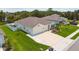 Aerial view of home featuring a well-manicured lawn, attached two-car garage, and colorful landscaping at 5904 114Th E Dr, Parrish, FL 34219