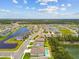 An aerial view of single-Gathering homes in a community with pond views and beautiful green landscaping at 5904 114Th E Dr, Parrish, FL 34219