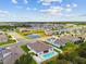 Overhead shot of neighborhood homes near scenic ponds, enhanced by lush greenery and mature trees at 5904 114Th E Dr, Parrish, FL 34219