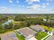 Beautiful aerial view of a home in a lush community with a lake and well-maintained landscaping at 5904 114Th E Dr, Parrish, FL 34219