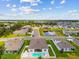 Aerial view of a home nestled in a neighborhood near a pond, highlighting community and serene surroundings at 5904 114Th E Dr, Parrish, FL 34219