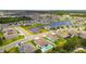 An aerial view of single-Gathering homes surrounding a pond, with a screened pool, and landscaping at 5904 114Th E Dr, Parrish, FL 34219