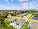 Aerial view showcasing a home with a private pool, fenced yard and neighborhood pond at 5904 114Th E Dr, Parrish, FL 34219