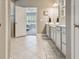 Bright bathroom showing double sinks and doorway to bedroom with plantation shutters at 5904 114Th E Dr, Parrish, FL 34219