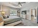 Comfortable bedroom with tray ceiling, fan and window with plantation shutters at 5904 114Th E Dr, Parrish, FL 34219