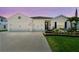 Charming single-Gathering home boasting a two-car garage, well-manicured lawn, and colorful flower beds at 5904 114Th E Dr, Parrish, FL 34219