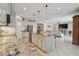 Open concept kitchen featuring a large island, stainless appliances, and breakfast bar at 5904 114Th E Dr, Parrish, FL 34219