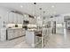 Open concept kitchen featuring a large island with seating and stainless steel appliances at 5904 114Th E Dr, Parrish, FL 34219