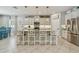 Modern kitchen with a central island, bar stools, and stainless steel appliances at 5904 114Th E Dr, Parrish, FL 34219