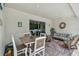 Inviting outdoor lanai with dining set, a glider and relaxing seating options, perfect for entertaining guests at 5904 114Th E Dr, Parrish, FL 34219