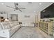 Spacious living room featuring tile floors, a large sectional sofa, and views into the kitchen at 5904 114Th E Dr, Parrish, FL 34219