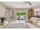 Bright living room featuring a sliding glass door leading to the outdoor pool area at 5904 114Th E Dr, Parrish, FL 34219