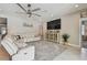 Bright and airy living room with tile floors and comfortable seating and entertainment center at 5904 114Th E Dr, Parrish, FL 34219