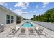 Inviting pool area features plenty of lounge chairs and seating, surrounded by a white privacy fence at 5904 114Th E Dr, Parrish, FL 34219
