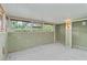 Unfinished basement with drop ceiling, exposed walls and partially covered windows at 6203 Courtside Dr # 21, Bradenton, FL 34210