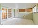 Unfinished basement with windows, drop ceiling and access to the outside via french doors at 6203 Courtside Dr # 21, Bradenton, FL 34210