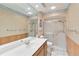 Bathroom featuring wood panelling, a large mirror and glass doored shower at 6203 Courtside Dr # 21, Bradenton, FL 34210