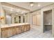 Bathroom featuring double sinks, a large mirror and a glass shower at 6203 Courtside Dr # 21, Bradenton, FL 34210