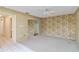 Spacious bedroom featuring leafy wallpaper, a ceiling fan and an adjoining closet with mirrored doors at 6203 Courtside Dr # 21, Bradenton, FL 34210