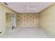 A carpeted bedroom featuring a ceiling fan and an adjacent closet with sliding mirrored doors at 6203 Courtside Dr # 21, Bradenton, FL 34210