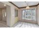 Traditional dining room featuring a large window for natural light and tiled flooring at 6203 Courtside Dr # 21, Bradenton, FL 34210