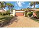 Charming villa featuring a well-manicured lawn, gravel driveway, and a two-car garage at 6203 Courtside Dr # 21, Bradenton, FL 34210
