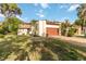 Charming villa featuring a well-manicured lawn, gravel driveway, and a two-car garage at 6203 Courtside Dr # 21, Bradenton, FL 34210