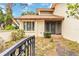 Charming villa featuring a well-manicured lawn with pathway to the front door and gated front porch at 6203 Courtside Dr # 21, Bradenton, FL 34210